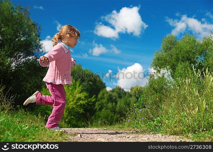 little girl runs across path outdoor