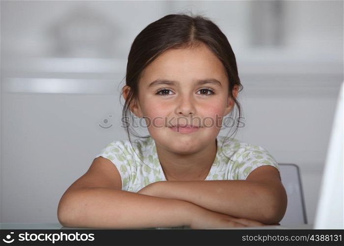 Little girl sat at table