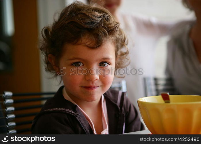 Little girl sat at the breakfast table