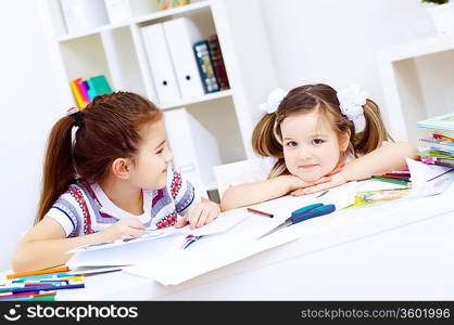 Little girl sitting and studying at home