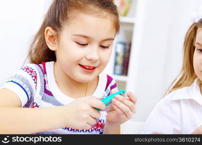 Little girl sitting and studying at home