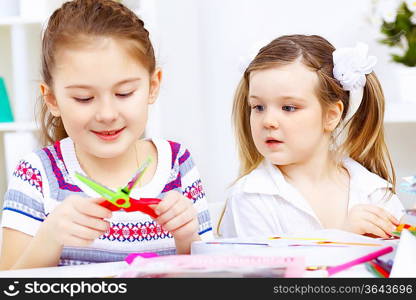 Little girl sitting and studying at home