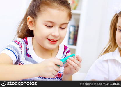 Little girl sitting and studying at home