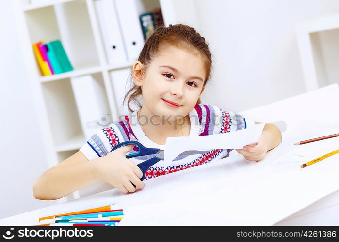 Little girl sitting and studying at home