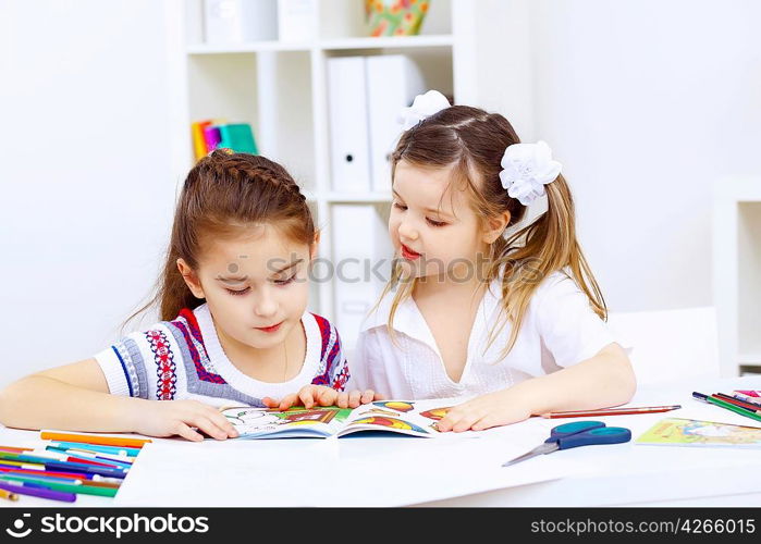 Little girl sitting and studying at home