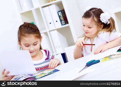 Little girl sitting and studying at home