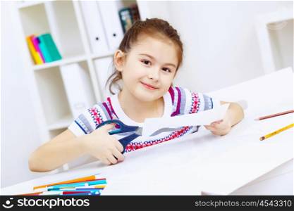 Little girl sitting and studying at home