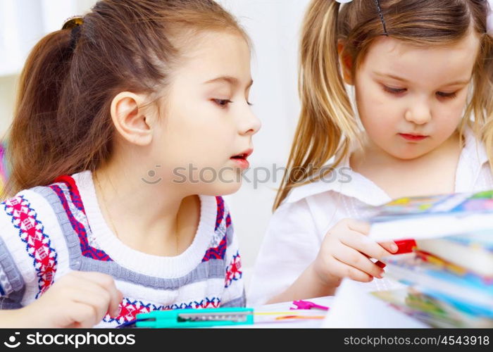 Little girl sitting and studying at home