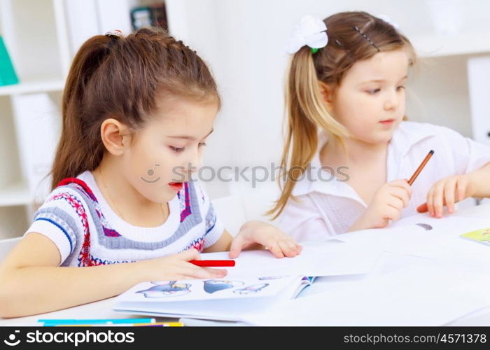 Little girl sitting and studying at home