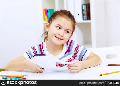 Little girl sitting and studying at home