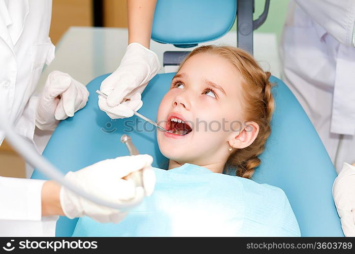 Little girl sitting in the dentists office