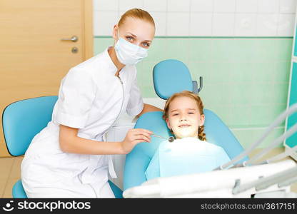 Little girl sitting in the dentists office