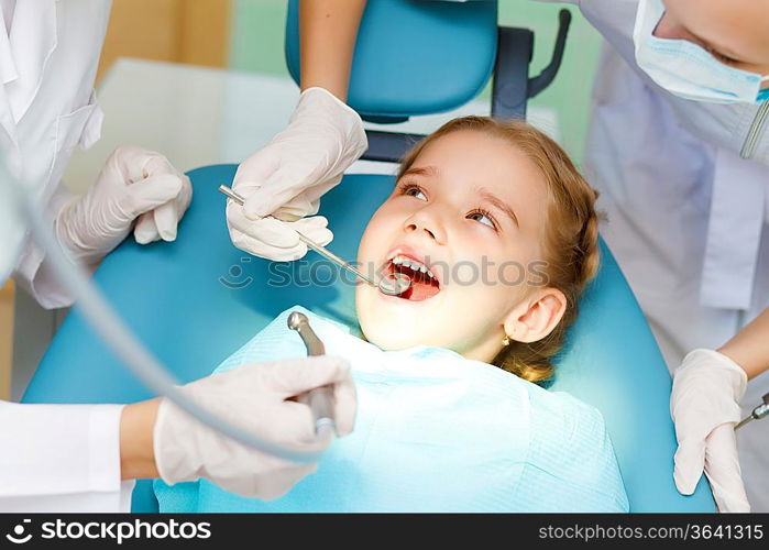 Little girl sitting in the dentists office