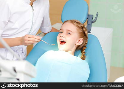 Little girl sitting in the dentists office