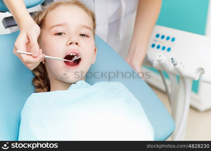 Little girl sitting in the dentists office