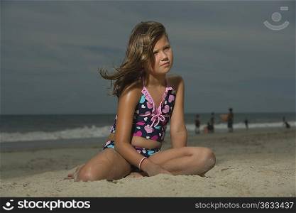 Little Girl Sitting on a Beach