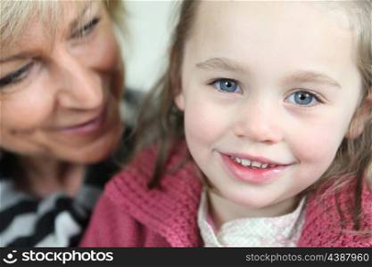 Little girl sitting with her grandmother