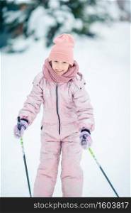 Little girl skiing in the mountains. Winter sport for kids.. Child skiing in the mountains. Winter sport for kids.
