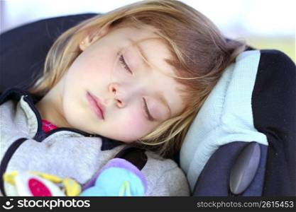 little girl sleeping on children car safety seat belt happy dreams