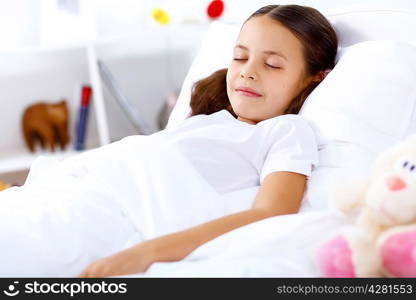 Little girl sleepng in her bed at home