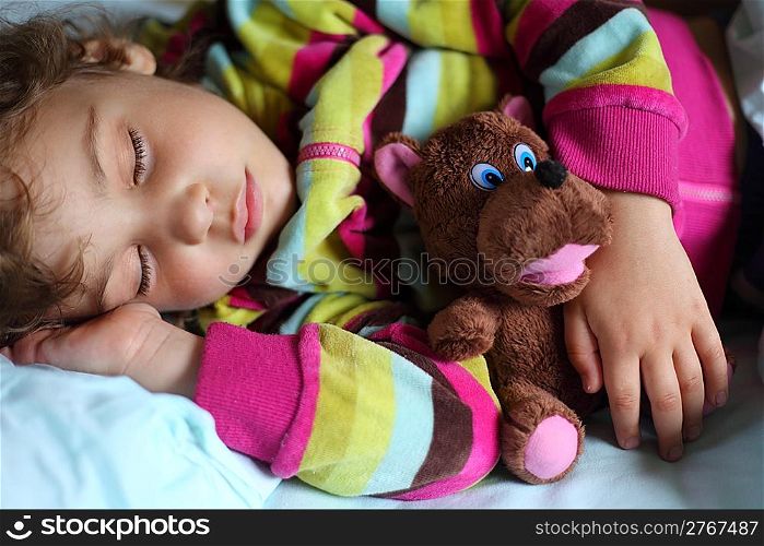little girl sleeps in train with puppet
