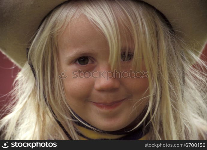 Little Girl Smiling and Wearing Hat