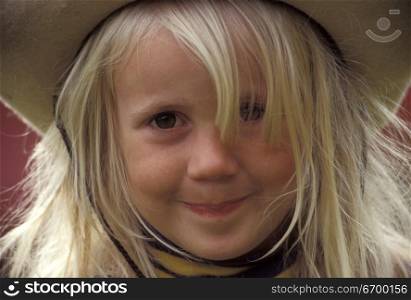 Little Girl Smiling and Wearing Hat