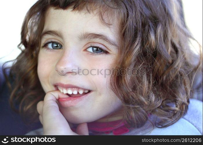 little girl smiling shy biting finger blue eyes