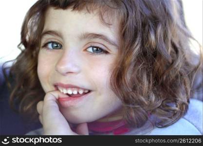 little girl smiling shy biting finger blue eyes