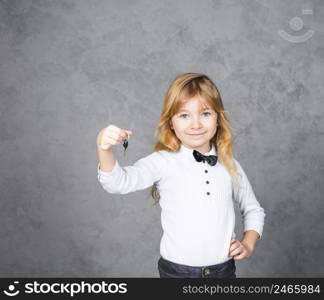 little girl standing with car key