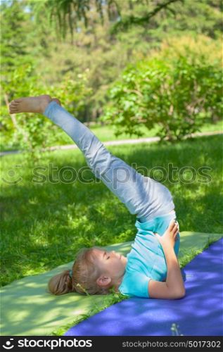 Little girl stretching at park