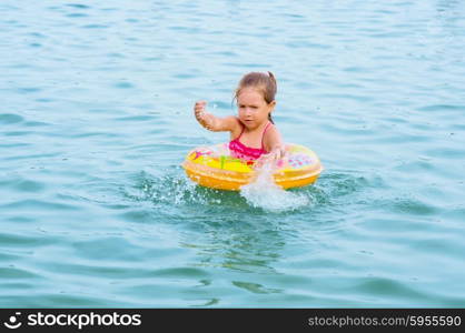 Little girl swimming on the lake