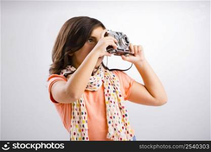 Little girl taking a photo with a vintage camera
