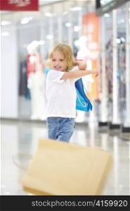 Little girl throws away from shopping bags