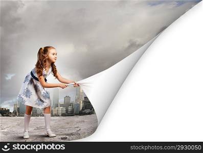 Little girl turning page
