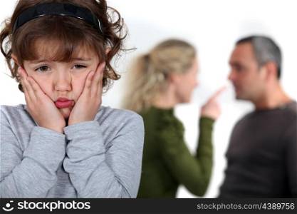 Little girl upset by parents arguing
