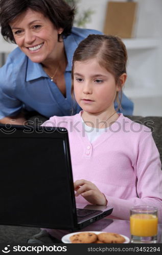 Little girl using laptop at home
