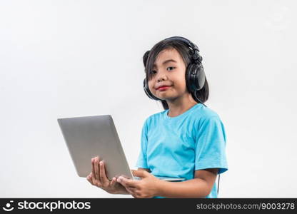 Little girl using laptop computer and listening lesson online 