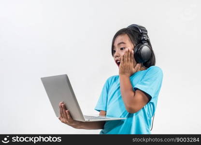 Little girl using laptop computer and listening lesson online 