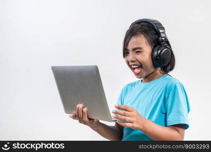 Little girl using laptop computer and listening lesson online 