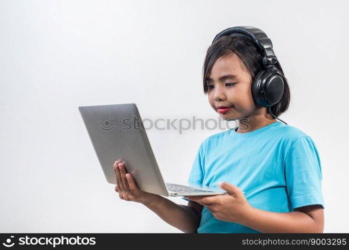 Little girl using laptop computer and listening lesson online 