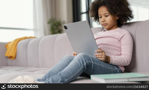 little girl using tablet home 2