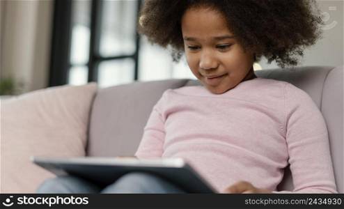 little girl using tablet home 3