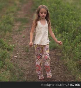 Little girl walking down path