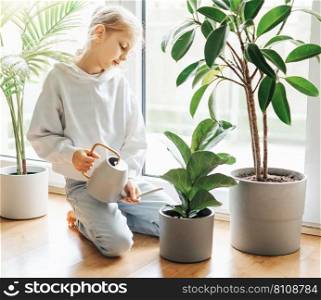 Little girl watering and caring for house plants