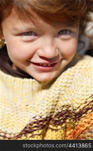 Little girl wearing jumper outdoors