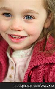 Little girl wearing pink cardigan