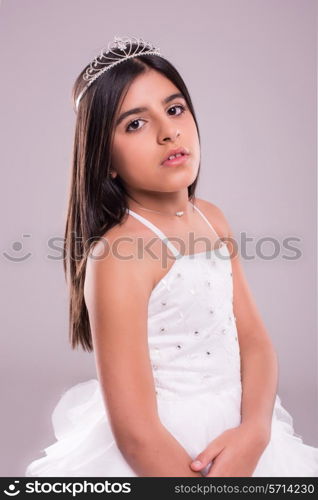 Little girl wearing princess fantasy over soft pink background