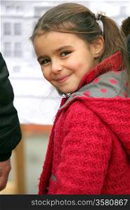 Little girl wearing red coat
