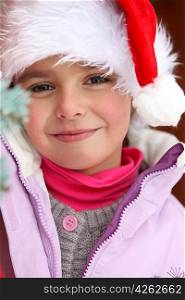 Little girl wearing Santa hat